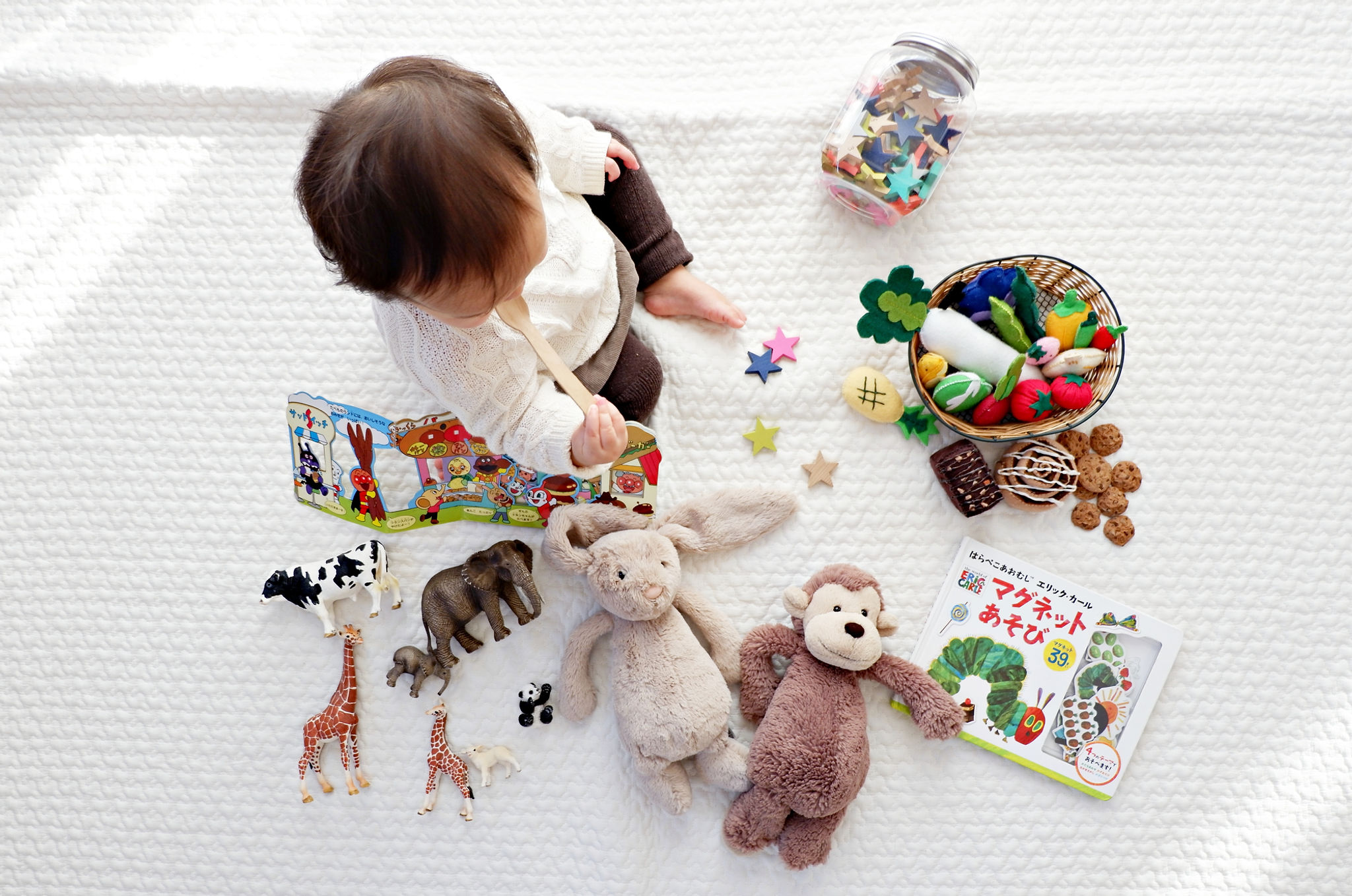 Toddler playing with a variety of toys.