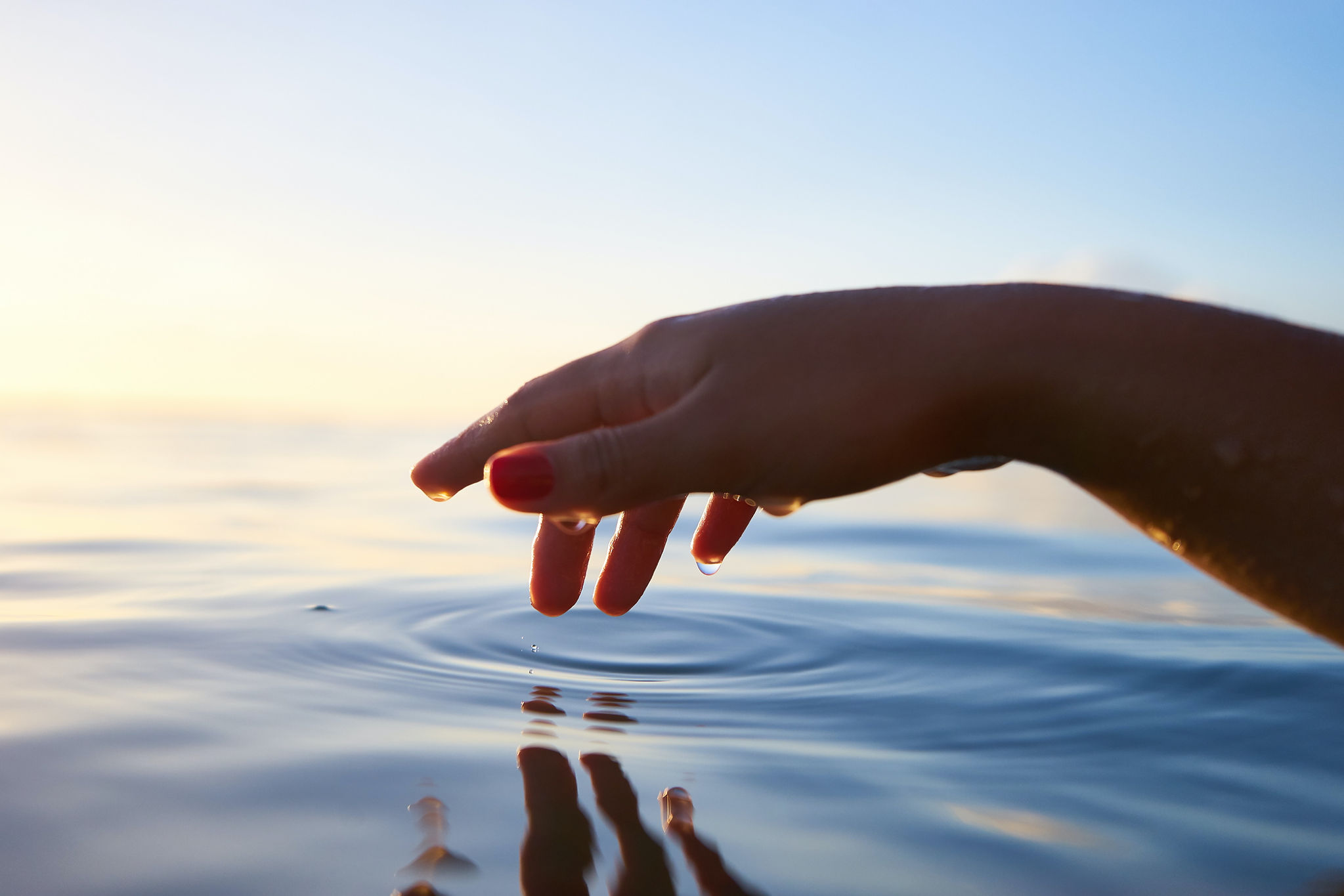 A wet hand over a body of water. | ENT Family Blog: The World's Rarest Allergies.