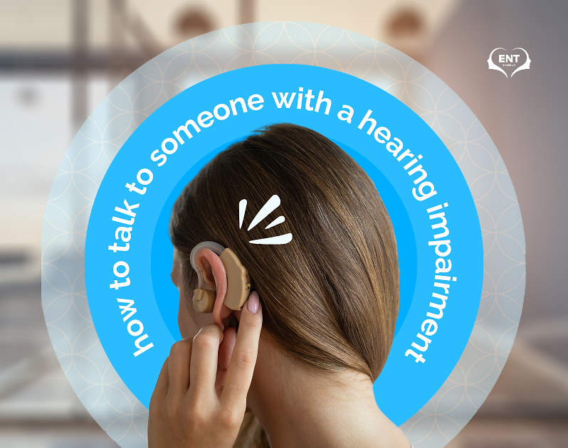 A woman touching a hearing aid on her ear. | ENT Family - How to Talk to Someone with a Hearing Impairment