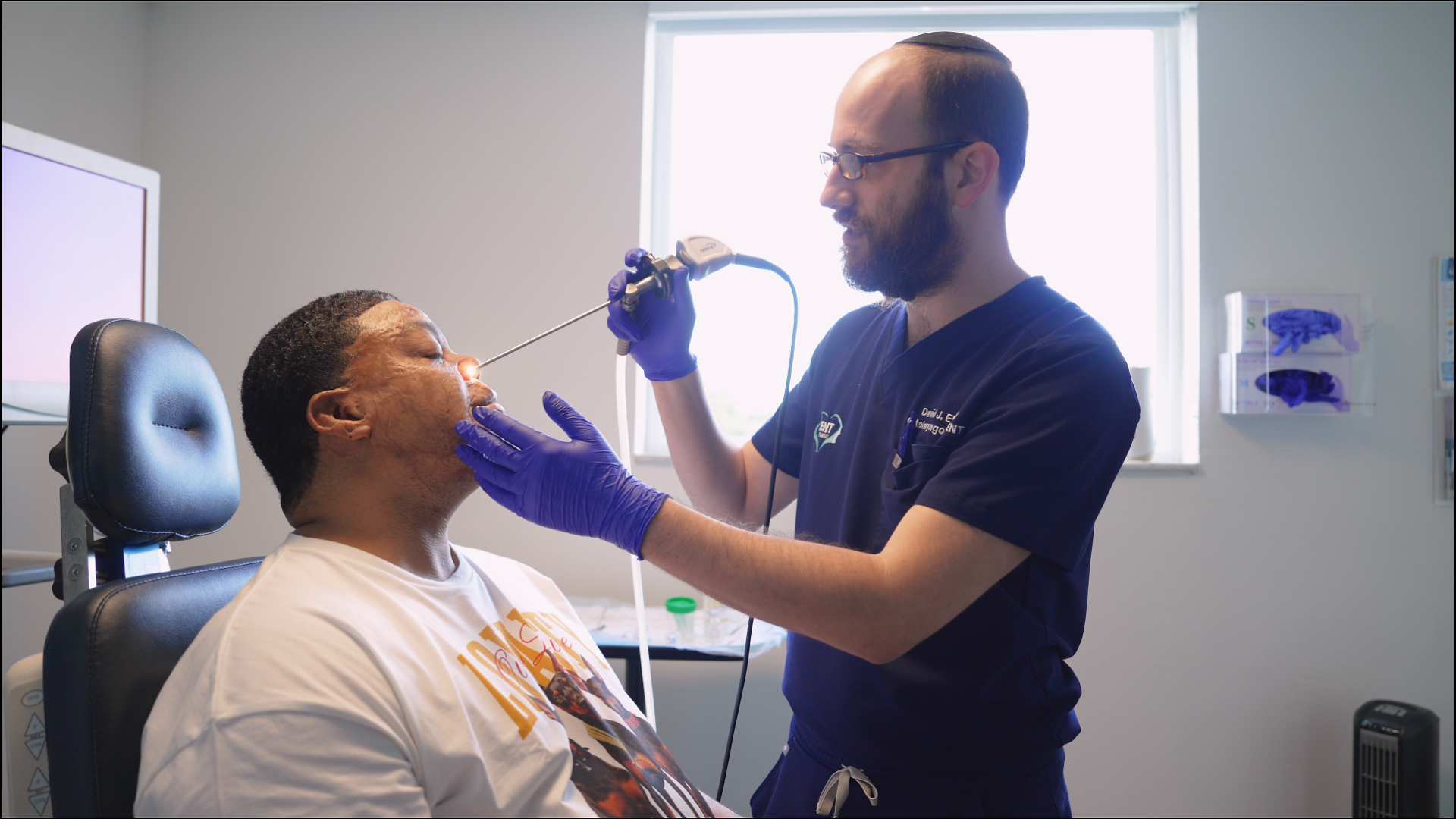 Dr. David Eleff performing a nasal endoscopy on a patient
