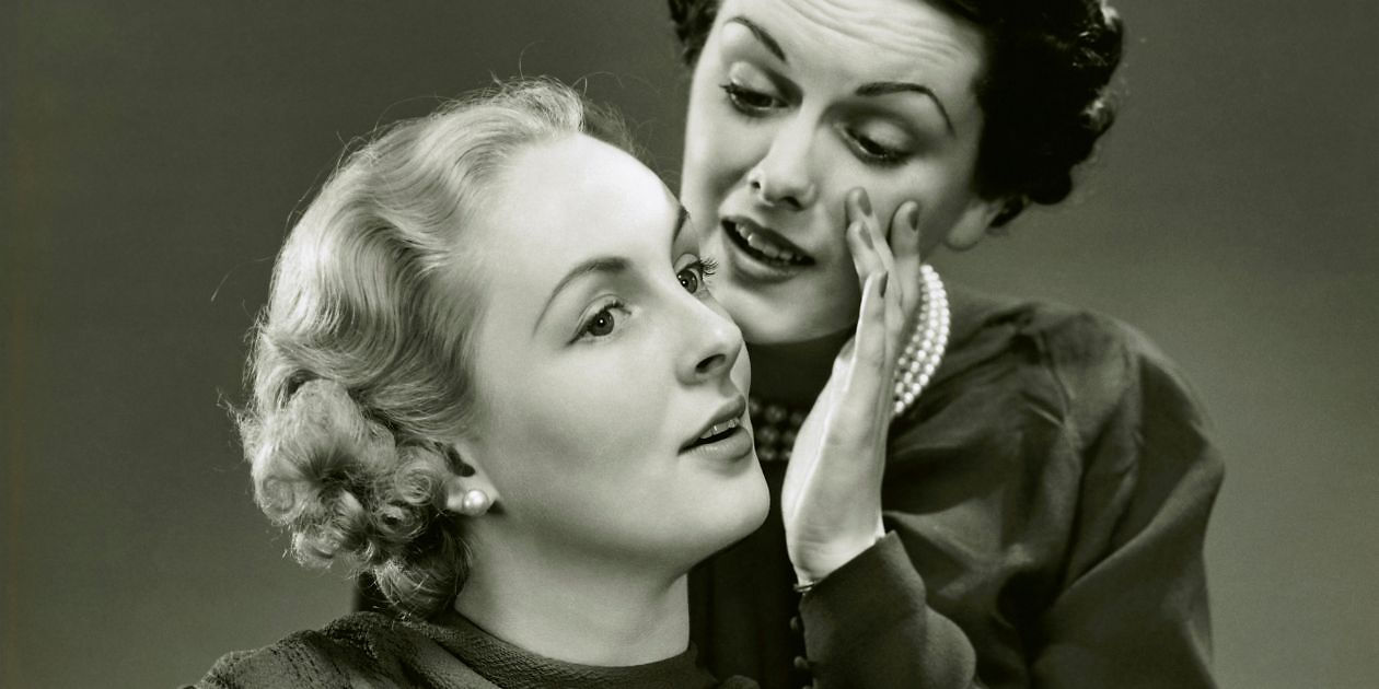 Woman whispering to another's ear. Habits to start and let go for healthy ears. ENT Family