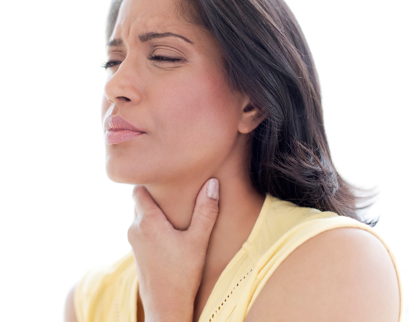 Woman touching her throat in pain